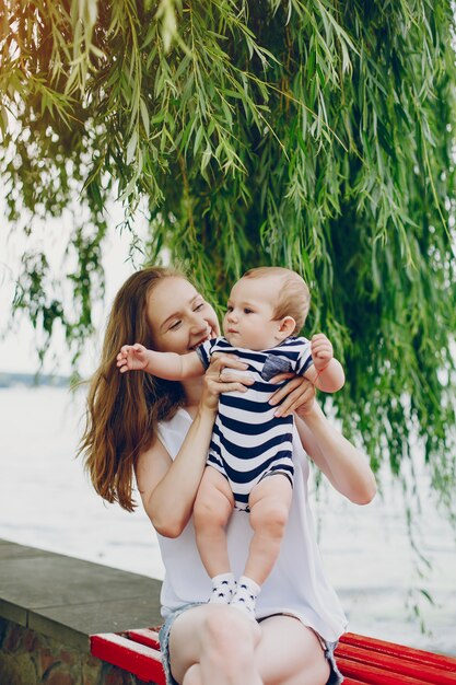 Mom and son relax in the park and walking around the river.