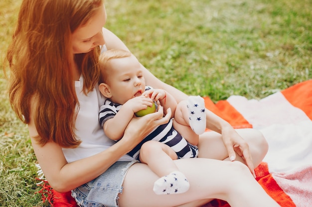 Free photo mom and son relax in the park.