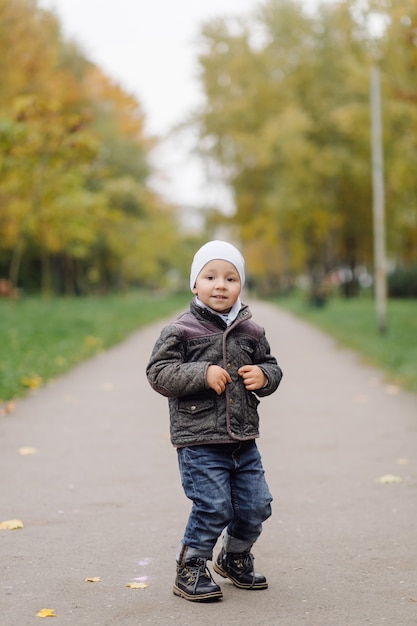 Mom and son walking and having fun together in the autumn park.