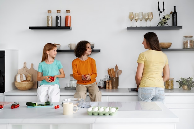 Free photo mom spending cooking with her kids