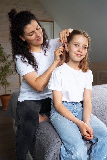 Mom taking care of  her daughter's hair