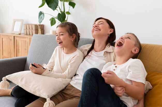 Mom watching television with her children