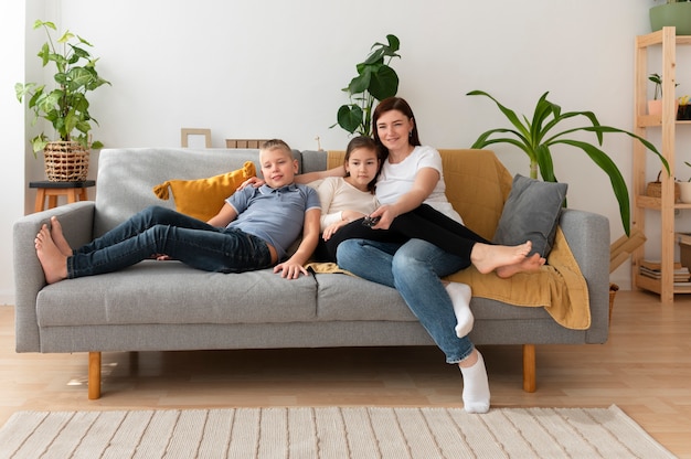 Mom watching television with her children