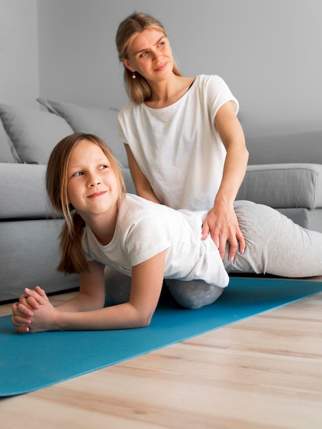 Mom with girl workout resitence exercise