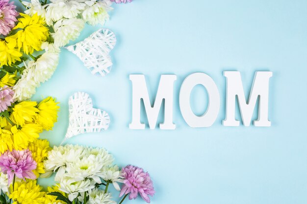 Mom words near hearts and bunches of fresh flowers