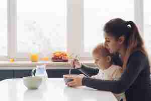 Free photo mommy and son having breakfast