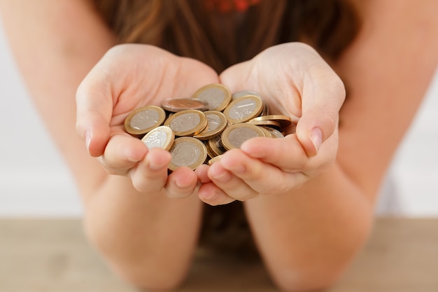 Money, finance. woman with heap of coins