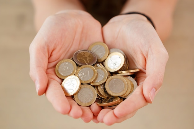 Free photo money, finance. woman with heap of coins