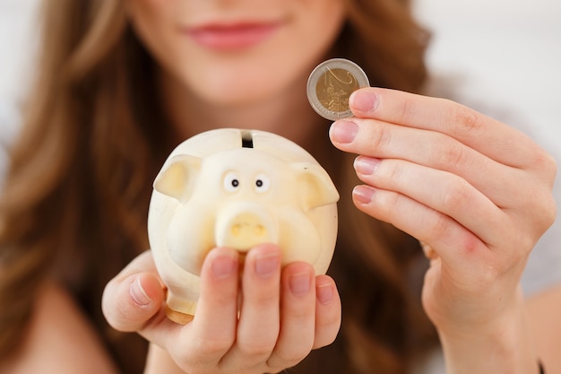 Money, finance. woman with piggy