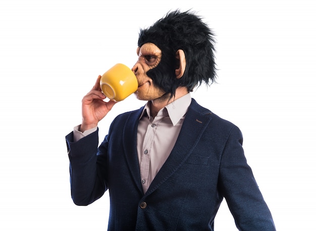 Free photo monkey man holding a cup of coffee