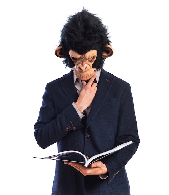 Free photo monkey man reading book