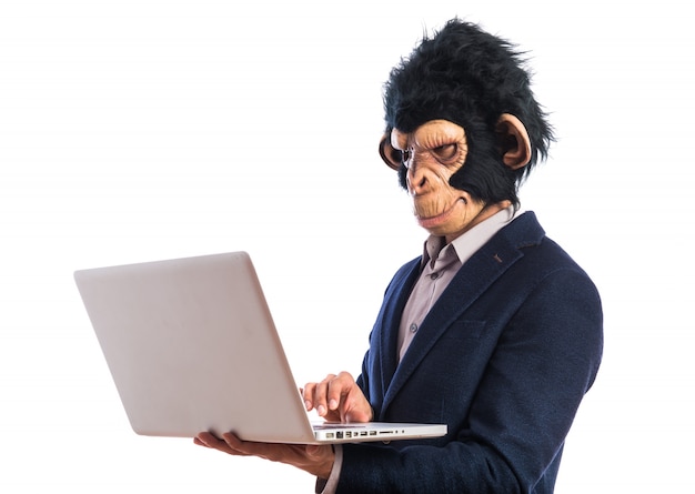 Monkey man with laptop over white background