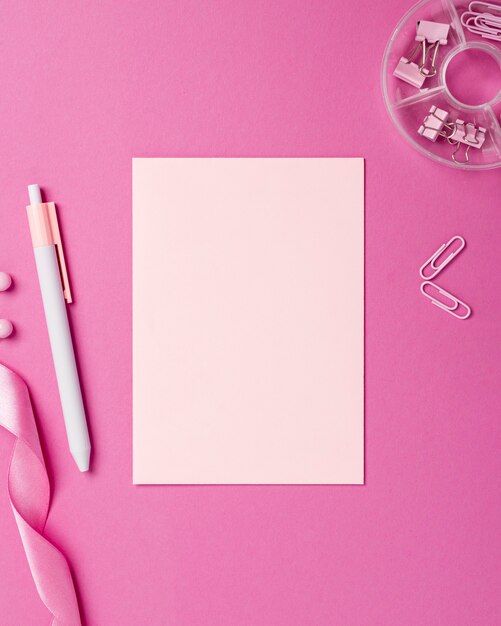 Monochromatic still life assortment with pink stationery objects