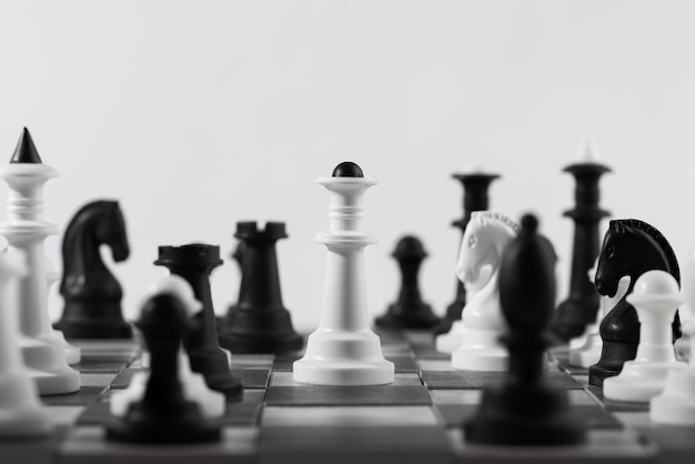 Monochrome chess pieces with game board