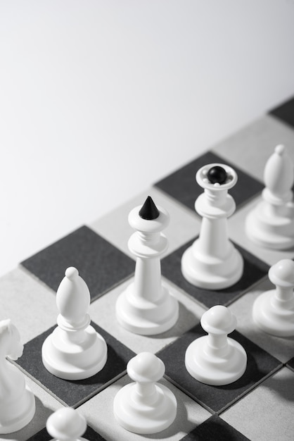 Monochrome chess pieces with game board