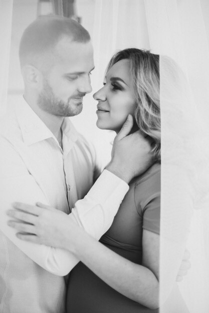 Monochrome portrait of pregnant wife and handsome husband