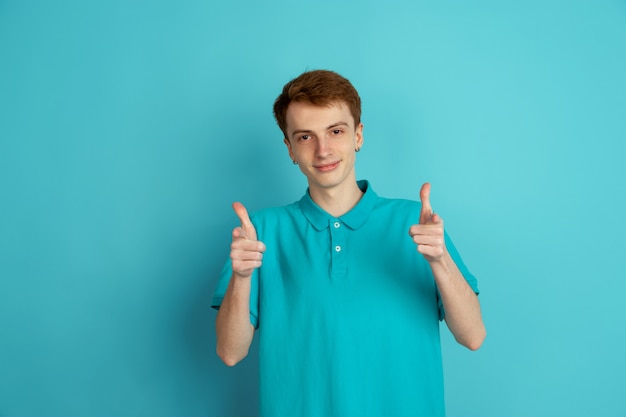 Monochrome portrait of young man on blue background