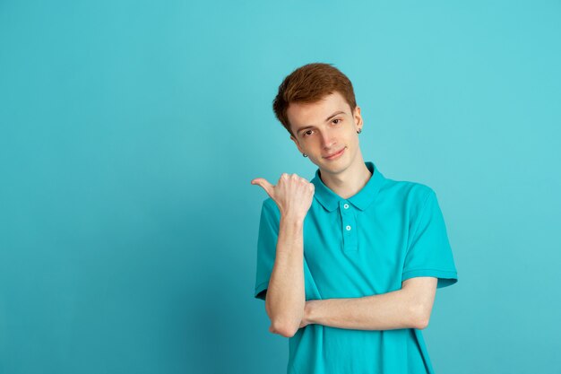 Monochrome portrait of young man on blue background