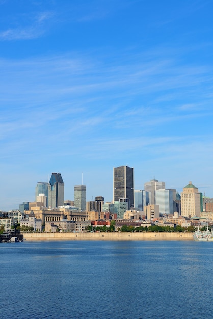 Montreal city skyline over river in the day with urban buildings