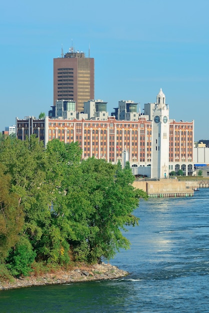 Montreal city skyline over river in the day with urban buildings