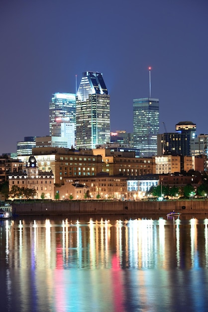 Free photo montreal over river at dusk with city lights and urban buildings