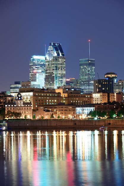 Montreal over river at dusk with city lights and urban buildings