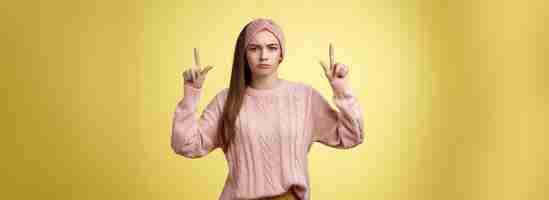 Free photo moody disappointed and upset unamused cute young european girl in knitted warm sweater headband