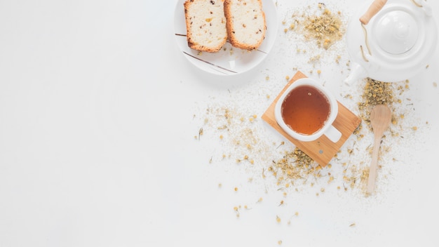 Morning breakfast bread and lemon tea with white ceramic teapot