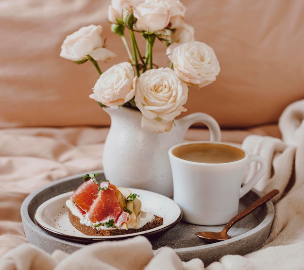 Morning coffee on tray with grapefruit and sandwich
