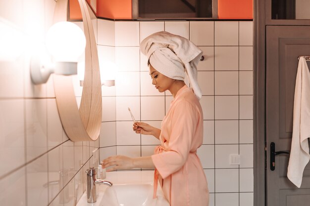 Morning routine of woman in pink robe