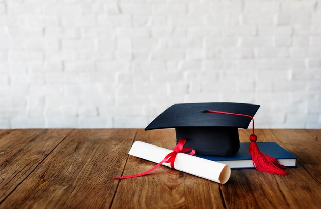 Mortar board and a graduation diploma