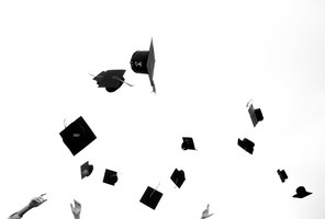 mortar boards in the air at a graduation