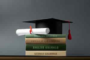 Free photo mortarboard and diploma on grammar books