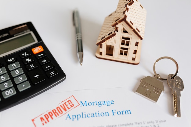 Mortgage contract and house figurine