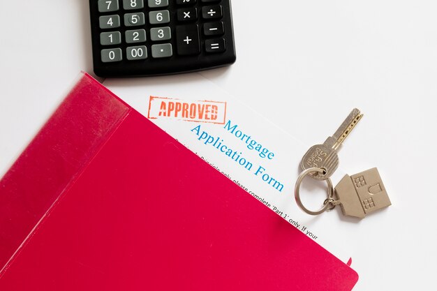 Mortgage papers and key on table