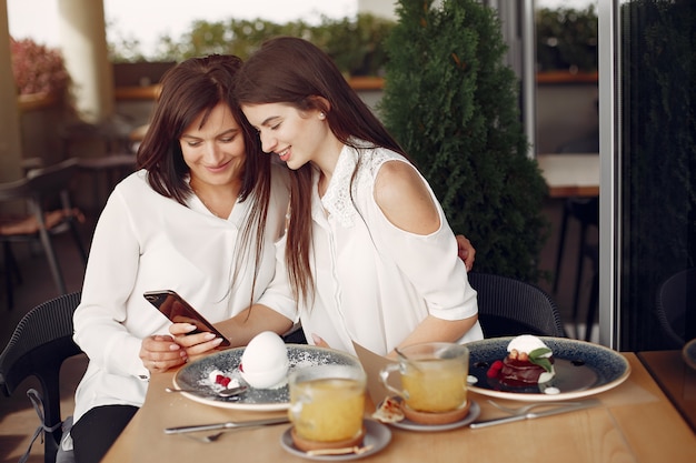 Mother and adult daughter sitting in a cafe