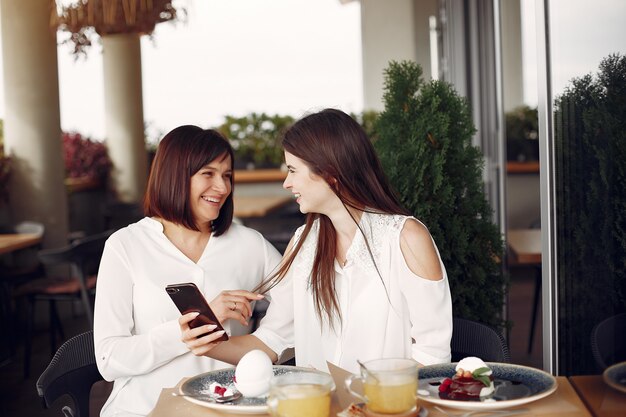 Mother and adult daughter sitting in a cafe