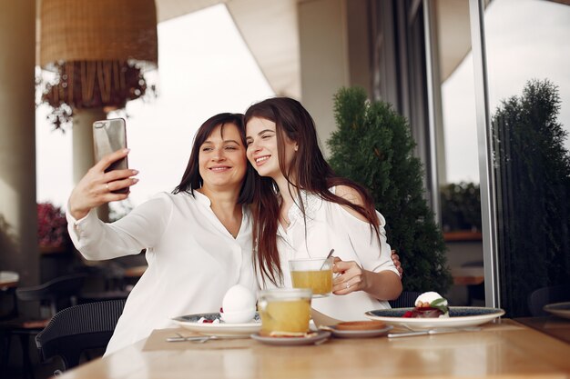 Mother and adult daughter sitting in a cafe