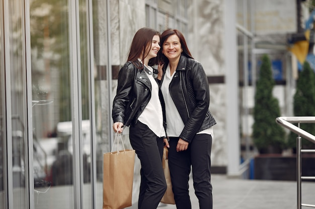 Mother and adult daughter with shopping bag