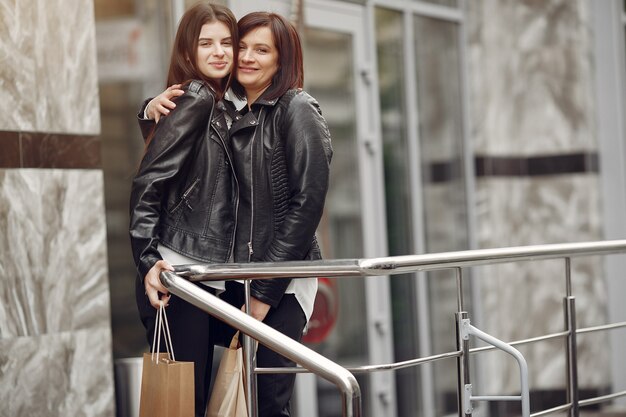 Mother and adult daughter with shopping bag