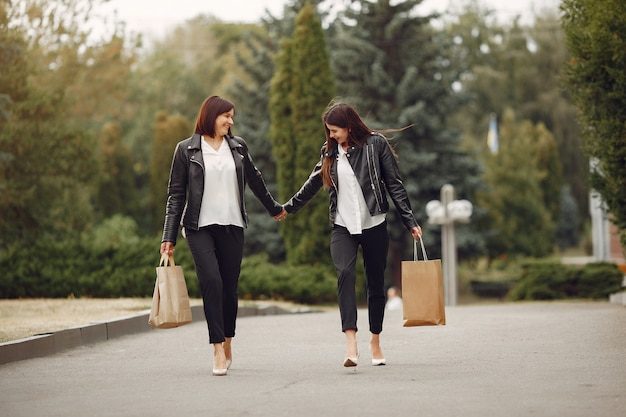 Mother and adult daughter with shopping bag