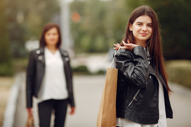 Mother and adult daughter with shopping bag