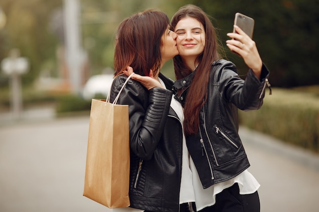 Mother and adult daughter with shopping bag