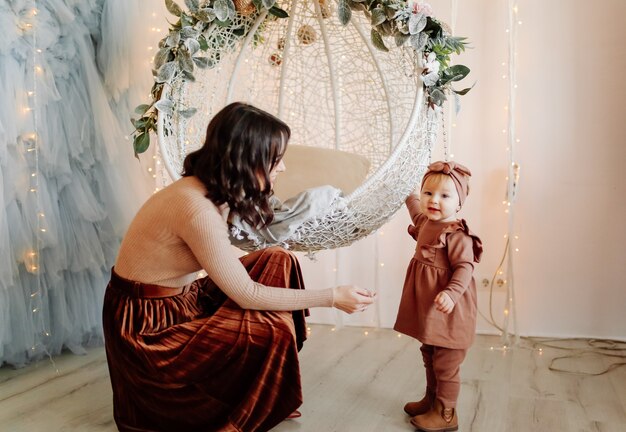 Mother and baby posing in swing