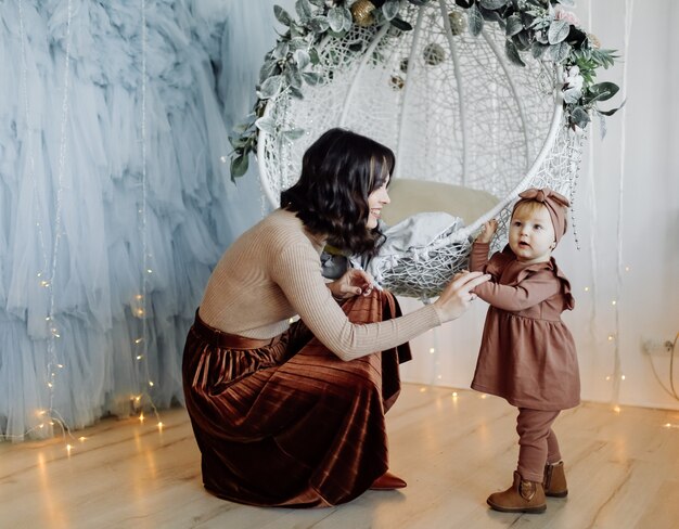 Mother and baby posing in swing