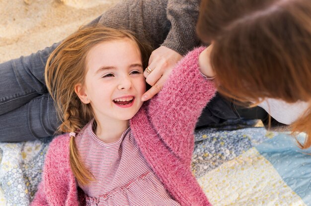 Mother being playful with adorable girl