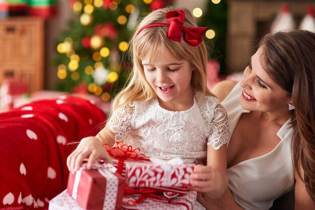 Mother bestowing daughter by plenty of presents