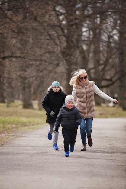 Free photo mother chasing her son in the park