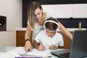 Free photo mother checking sons homework