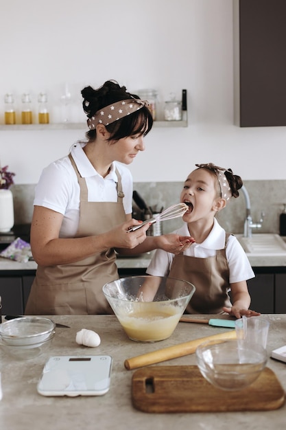 Mother and child baking and having fun at kitchen